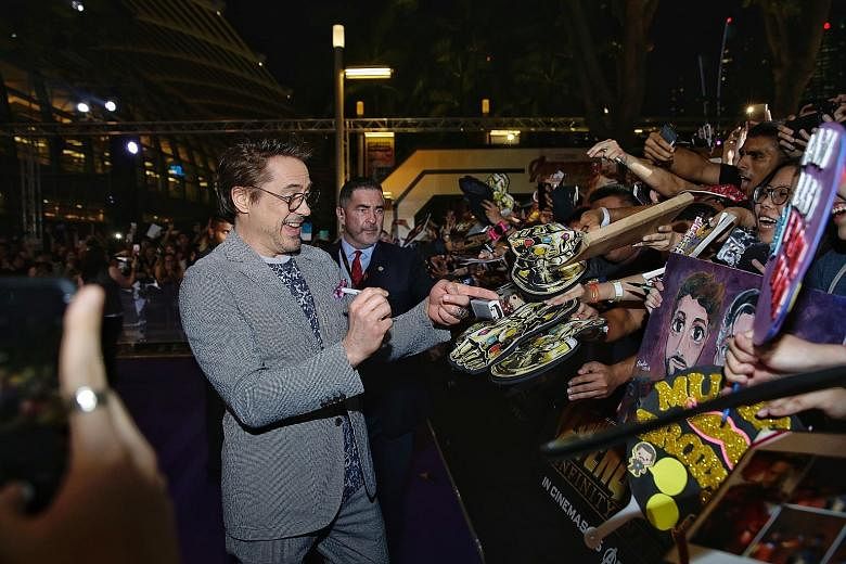 Actor Robert Downey Jr, who plays Iron Man, signing autographs for fans at the Marvel Studios' Avengers: Infinity War fan event at the Marina Bay Sands Event Plaza yesterday. About 4,000 fans were in attendance, with 3,000 more watching a live stream