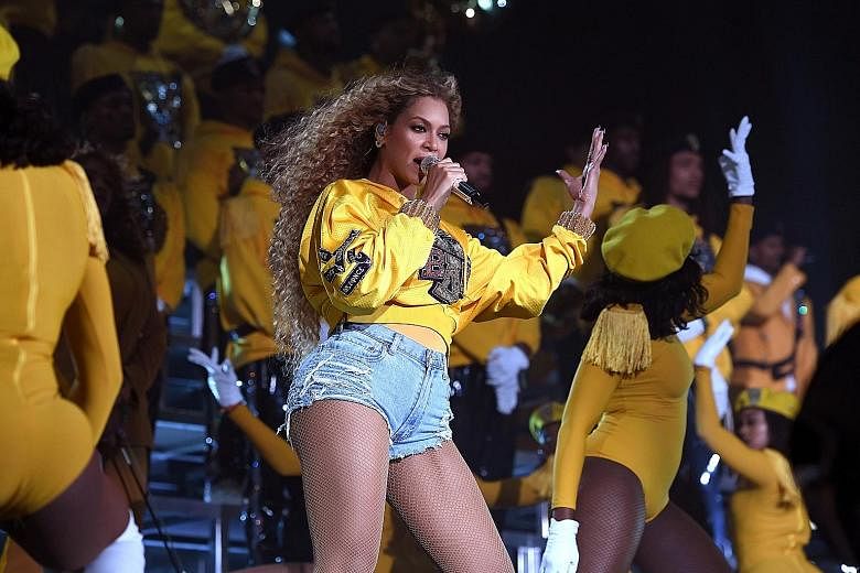 Beyonce wows the crowd in an all-American outfit of tight jean shorts and a collegiate sweatshirt.
