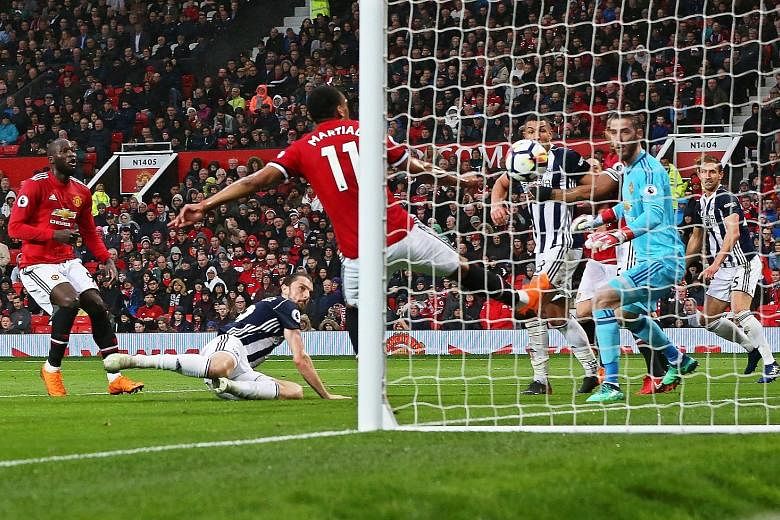 West Brom's Jay Rodriguez (on ground) scoring the goal that beat Manchester United 1-0 in the Premier League on Sunday. United's defeat also meant that Manchester City clinched the league title with five games left to play.