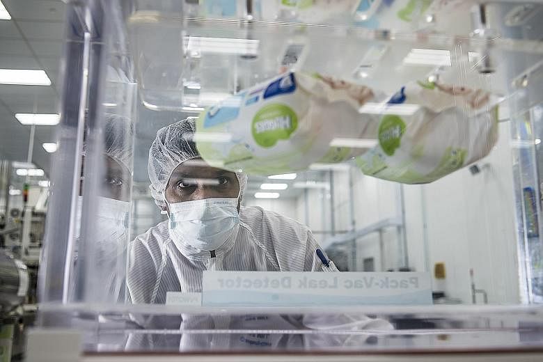 An employee carrying out quality inspection at Kimberly-Clark's Tuas plant, which produces about 2.4 million baby wipes a year - a capacity that is set to rise to five million by the second quarter of next year.