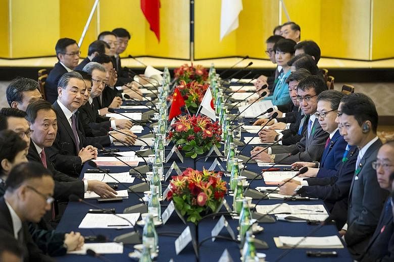 Visiting Chinese Foreign Minister Wang Yi (sixth from the front on the left) with his Japanese counterpart Taro Kono (fifth from the front on the right) and other officials at the dialogue in Tokyo yesterday. On trade, both China and Japan pledged to