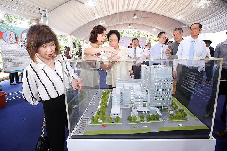 From left: Senior Minister of State for Health Amy Khor, National Skin Centre director Tan Suat Hoon and National Healthcare Group chairman Kay Kuok checking out a model of the new NSC building at the groundbreaking ceremony.