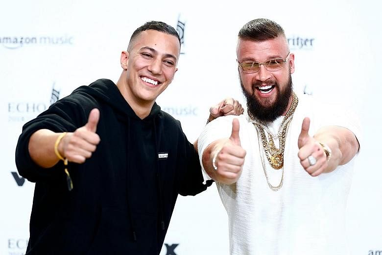 Prince Harry and Meghan Markle were set up on a blind date by a mutual friend and they hit it off instantly. In their album last year, German rappers Farid Bang (far left) and Kollegah boasted about how their bodies are "more defined than Auschwitz p