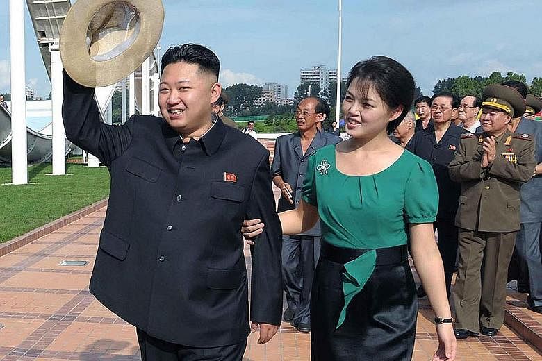 An undated photo released by North Korea in 2012 shows Mr Kim Jong Un accompanied by his wife Ri Sol Ju on a visit to a wading pool at the Rungna People's Pleasure Ground in Pyongyang.