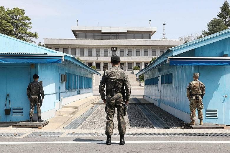 South Korean and US soldiers on guard at the inter-Korean truce village of Panmunjom, the venue for talks between South Korea's President Moon Jae In (top) and the North's leader Kim Jong Un next Friday.