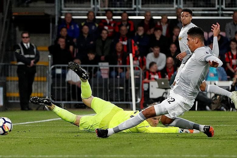 Manchester United's Chris Smalling sliding in to convert a lay-off from Jesse Lingard and score the opener against Bournemouth at Dean Court. United bounced back from their weekend loss to win 2-0 and consolidate second place in the Premier League, f