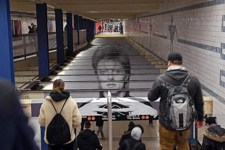 Photos and posters of David Bowie at the Broadway-Lafayette subway station in New York give commuters something to look at on their journey.