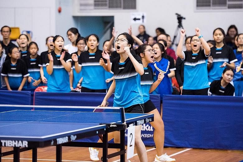 Glenda Teo (front) and Ng Yi Hsuan of Nanyang Girls' High School celebrating a point during the Schools National Girls' B Division table tennis final at Pasir Ris Sports Hall yesterday. Nanyang beat Raffles Girls' School 3-1.