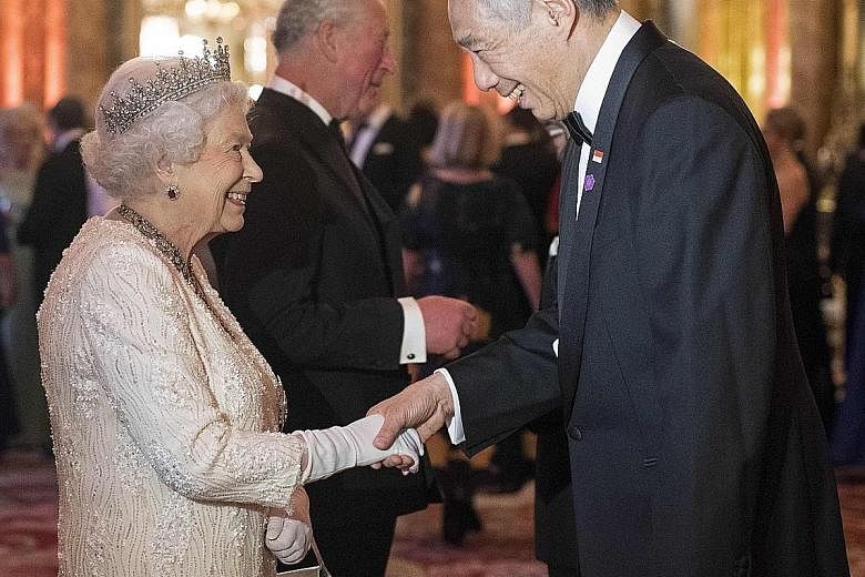 Above: Prime Minister Lee Hsien Loong and Mrs Lee on their way to the state dinner hosted by Britain's Queen Elizabeth II in London yesterday. Right: Queen Elizabeth II greeting Mr Lee in the Blue Drawing Room before The Queen's Dinner at Buckingham 