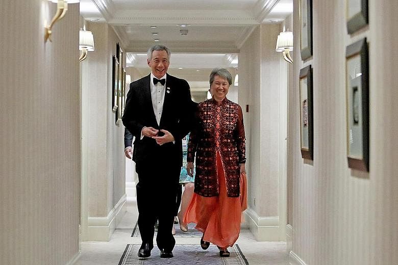 Above: Prime Minister Lee Hsien Loong and Mrs Lee on their way to the state dinner hosted by Britain's Queen Elizabeth II in London yesterday. Right: Queen Elizabeth II greeting Mr Lee in the Blue Drawing Room before The Queen's Dinner at Buckingham 