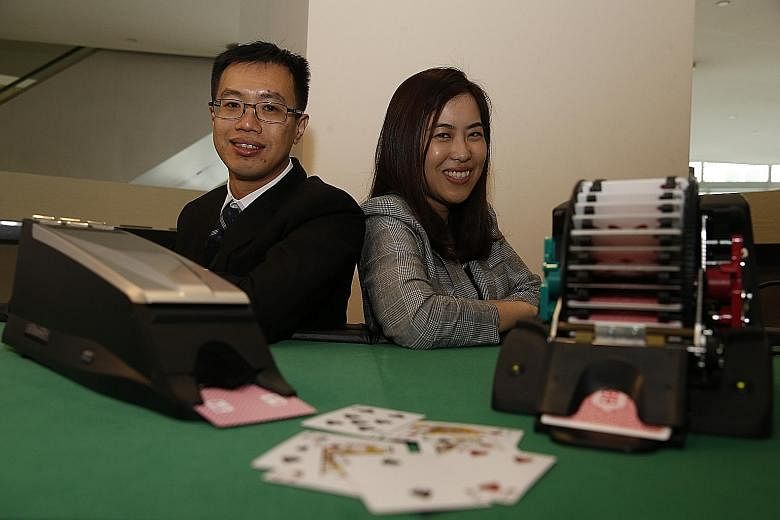 Casinos here use new technology to ensure honest gaming, said Mr Chan Wei Siang (far left), assistant director of gaming technology at the Casino Regulatory Authority, seen here with Ms He Shujia, head of inspection and compliance.