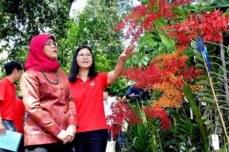 President Halimah Yacob with National Orchid Garden deputy director Whang Lay Keng at the opening of the inaugural Singapore Garden Festival Orchid Show.