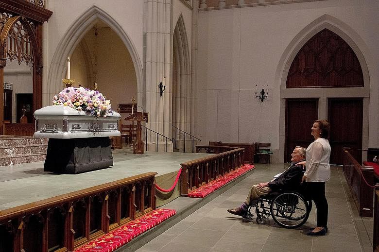 Former US president George H.W. Bush looking at the casket of his late wife, former first lady Barbara Bush, with his daughter Dorothy Bush Koch during the visitation at St Martin's Episcopal Church in Houston, Texas, on Friday. Former United States 