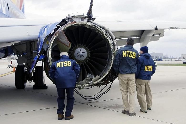 Investigators examining the damaged engine of the Southwest Airlines plane involved in last week's accident. The engine had blown apart, killing a passenger and forcing an emergency landing.