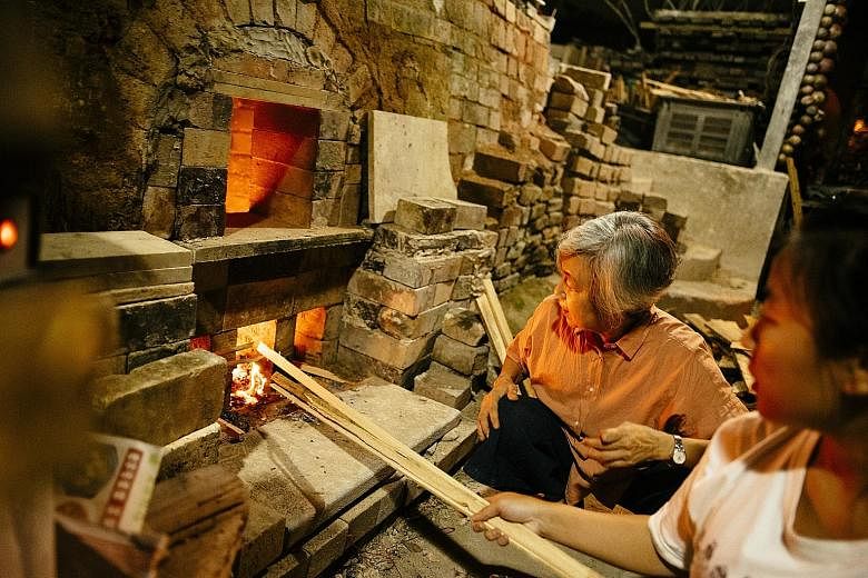 Left: Thow Kwang Industry project director Yulianti Tan, 59, and studio director Stella Tan, 27, stoke the company's dragon kiln. Below: Sam Mui Kuang Pottery is believed to have run one of the first dragon kilns here. It had to make way in 1994 for 