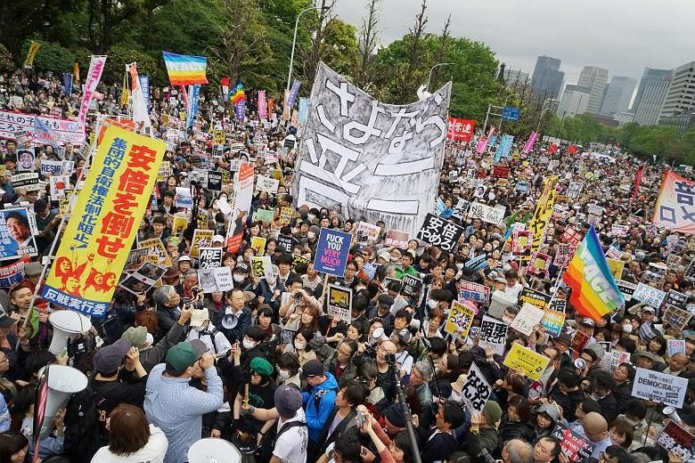 Demonstrators protesting against Prime Minister Shinzo Abe outside the National Diet building in Tokyo on April 14. Approval ratings for Mr Abe's Cabinet fell to 38.4 per cent, according to a Jiji poll conducted from April 6 to 9. Prime Minister Shin