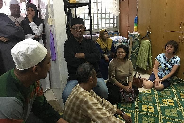 Jalan Besar GRC MP and Central Singapore District Mayor Denise Phua (right) speaking to family members at the home of the late Mr Muhamed Senin, who was struck by a falling tree branch near Block 7 North Bridge Road on Saturday.