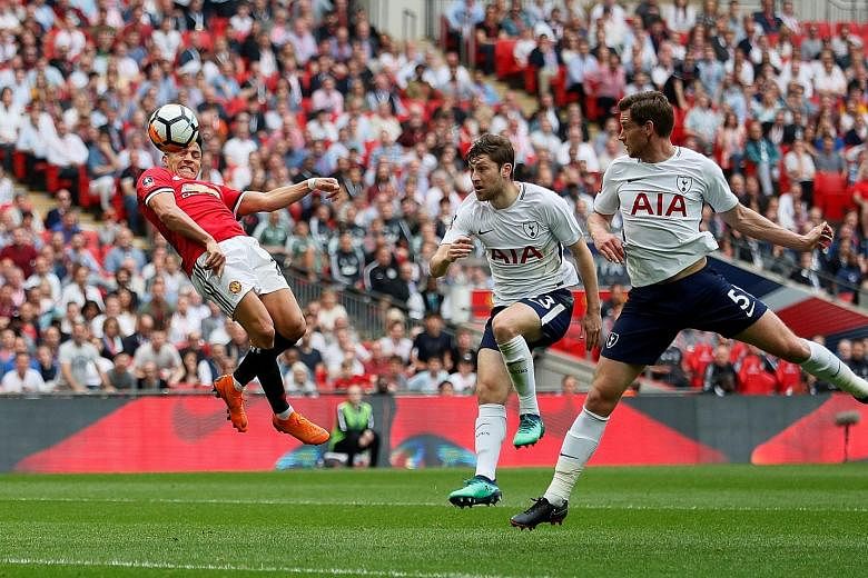 Manchester United forward Alexis Sanchez heads in the equaliser as the helpless Tottenham defenders Ben Davies and Jan Vertonghen (right) look on.