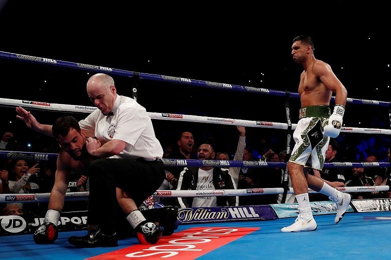 Referee Victor Loughlin stopping the fight after Amir Khan floored Phil Lo Greco for the second time in their bout in Liverpool on Saturday.