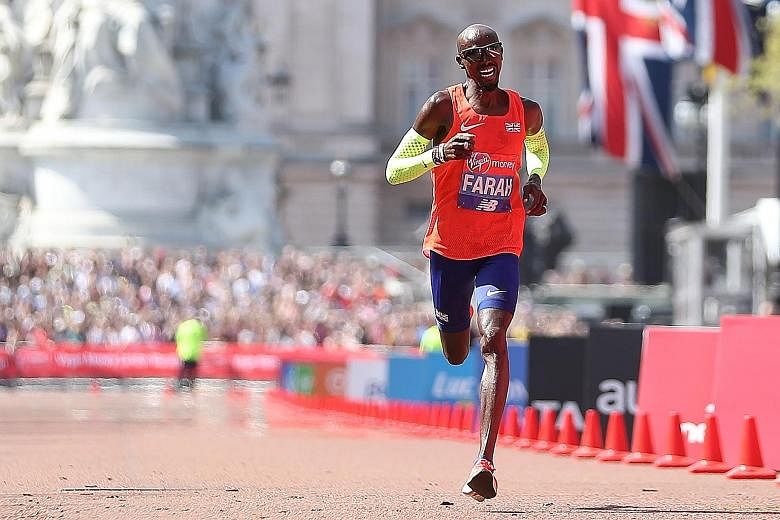 Britain's Mo Farah crossing the finish line of the London Marathon yesterday in a national record of 2hr 6min 21sec. After the race, he claimed some marathon staff had been more focused on taking pictures than helping runners.