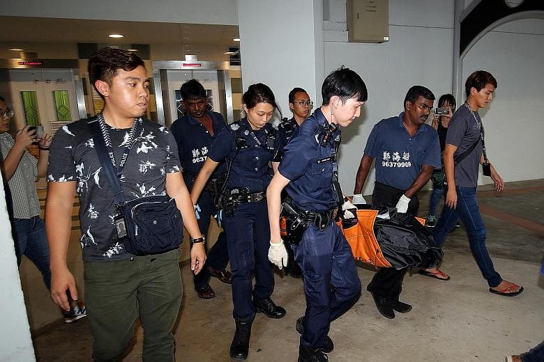 Police officers and undertakers removing the body of 77-year-old Madam Tay Quee Lang on Feb 13 last year. Her Indonesian maid, Minah, pleaded guilty to a charge of culpable homicide for killing the elderly woman.