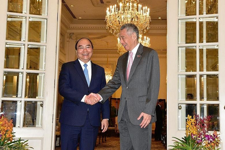 Vietnamese Prime Minister Nguyen Xuan Phuc with Prime Minister Lee Hsien Loong at the Istana yesterday. Mr Phuc, who is here on a three-day official visit ahead of the Asean Summit this weekend, said: "Singapore has always been a trusted companion an