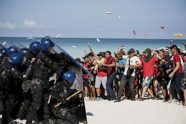 Mock protesters facing off against anti-riot police during a security exercise on the Philippine resort island of Boracay yesterday, ahead of its six-month shutdown and clean-up.