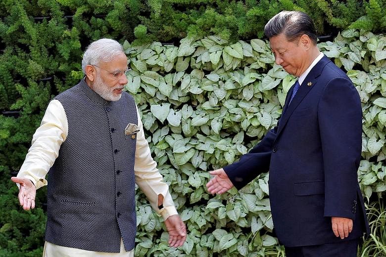 Prime Minister Narendra Modi and President Xi Jinping at a Brics (Brazil, Russia, India, China and South Africa) Summit in Goa, India, in 2016. This week's meeting takes place after a year of fraught ties between the giant neighbours.