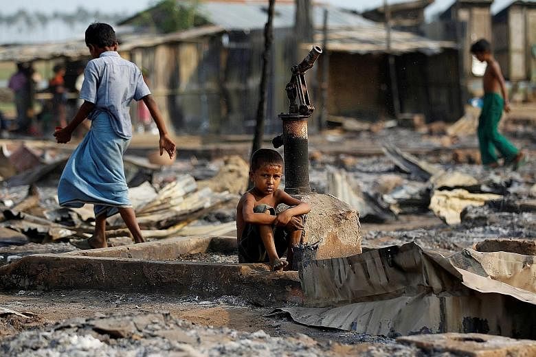 A boy sitting in an area of a camp for internally displaced Rohingya Muslims that was destroyed by fire in Myanmar's Rakhine state in this 2016 photo. The US State Department is leading an investigation that has involved interviews of Rohingya men an
