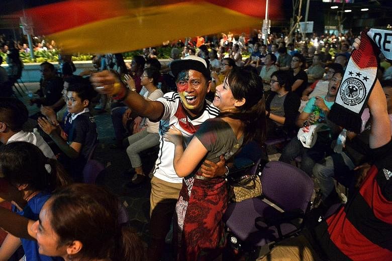 This happy couple celebrating Germany's fifth World Cup title were among more than 1,000 fans who turned up for the Sports Hub's screening of the final in the wee hours of July 14, 2014.