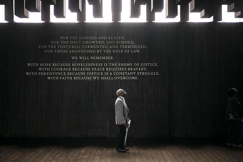 A visitor to the National Memorial For Peace And Justice in Montgomery, Alabama, on Thursday. The Equal Justice Initiative, which is behind the project and documented the lynching of more than 4,400 black people in the US between 1877 and 1950, says 