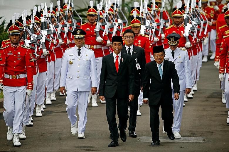 Indonesia President Joko Widodo and Vice-President Jusuf Kalla during a ceremony in Jakarta last year. Mr Joko is hard pressed to find a running mate for next year's election who has all the key qualifications that his current V-P has.