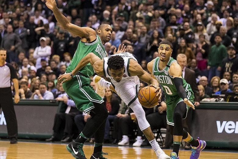 Milwaukee Bucks forward Giannis Antetokounmpo driving for the basket around Boston Celtics forward Al Horford (left), as forward Jayson Tatum fails to keep pace in Game 6 of their NBA play-offs first-round clash. The series is tied at 3-3.