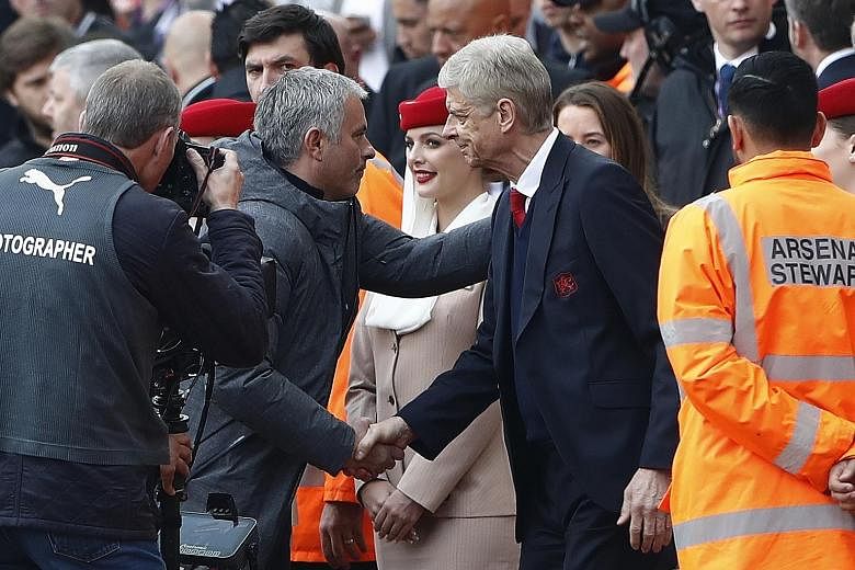 Jose Mourinho and Arsene Wenger shaking hands before their teams clashed at the Emirates in May last year. Mourinho has urged the Old Trafford crowd to give the Frenchman a courteous reception for his final game at the stadium.