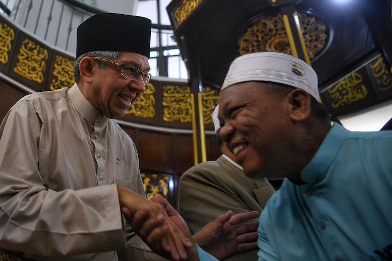 Dr Yaacob Ibrahim greeting a congregant at Al-Mukminin Mosque in June last year. Noting the progress made by the Malay/Muslim community, the 62-year-old says: "Now, it's how we can push that even higher."