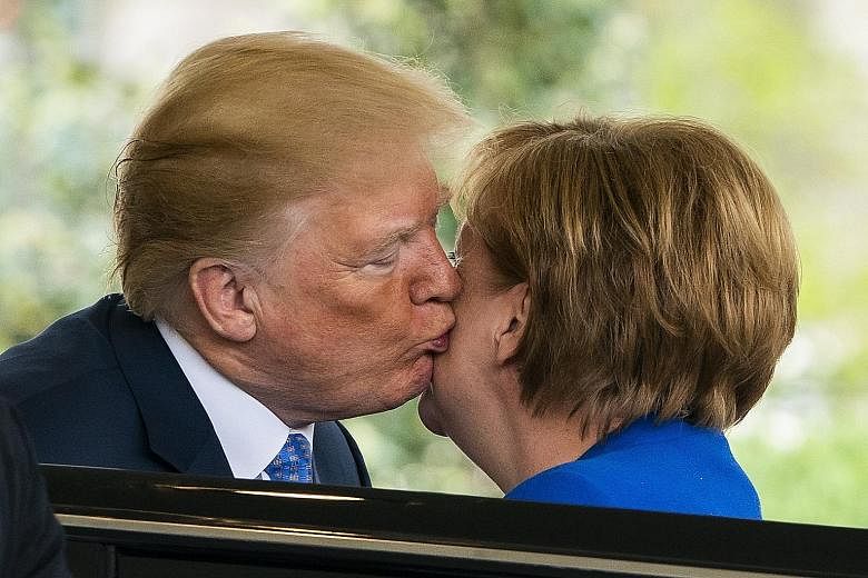 US President Donald Trump greeting German Chancellor Angela Merkel at the West Wing of the White House in Washington on Friday. German business leaders yesterday voiced disappointment after meetings between the two leaders appeared to have produced n