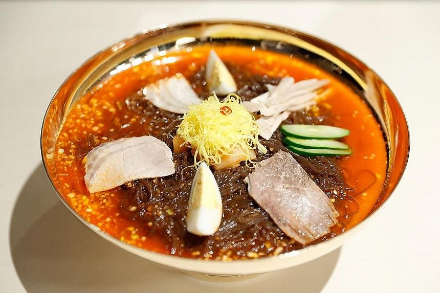 A worker preparing to serve "Pyongyang naengmyeon", a cold noodle dish, at the Nampo Myeonok noodle bar restaurant in Seoul yesterday. Demand for North Korea's signature dish peaked all over the South's capital after it was featured on the menu at th