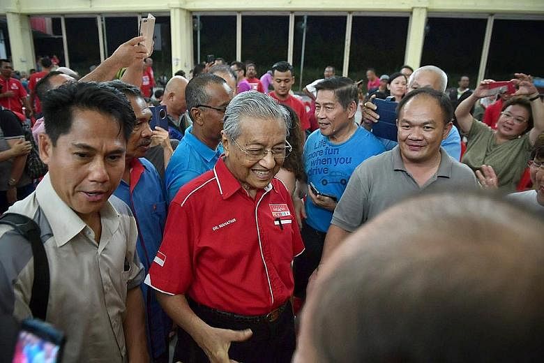 Dr Mahathir Mohamad arriving at Dewan Ho Peng in Langkawi's main town, Kuah, for a rally yesterday.