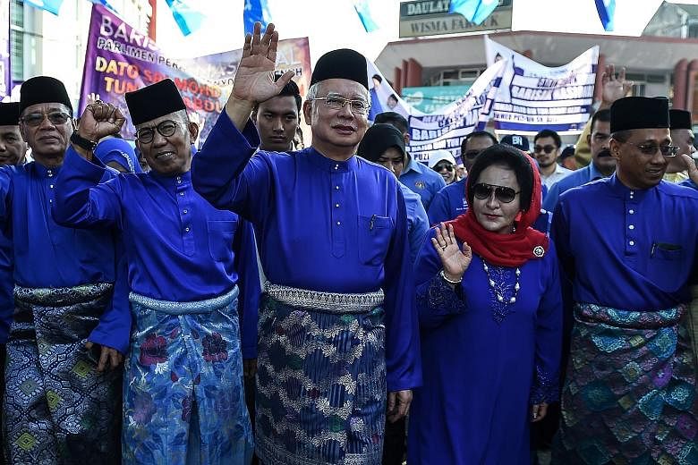 Malaysia's Prime Minister Najib Razak, with his wife Rosmah Mansor, arriving at the nomination centre to submit his election documents in Pekan, Pahang, yesterday.