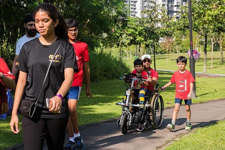 The first Special People Bi/Triathlon, organised by social enterprise The Special People and supported by the Jalan Kayu Community Sports Council, was held yesterday. Left: Former national track star K. Jayamani cheers on her foster son, 21-year-old 