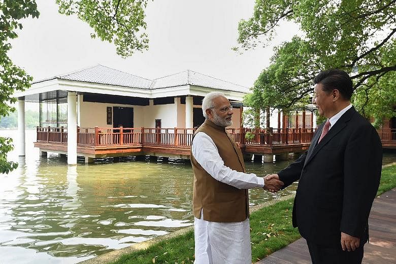 Chinese President Xi Jinping with Indian PM Narendra Modi at Wuhan's East Lake. The two leaders issued "strategic guidance to their respective militaries" to strengthen communication and build trust, and both sides agreed to handle differences with m