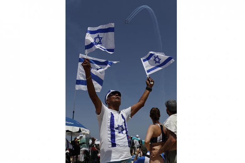 An air show during the 70th Independence Day festivities in Tel Aviv on April 19. Israel marked 70 years since the founding of the country according to the Hebrew calendar with a national holiday celebration.