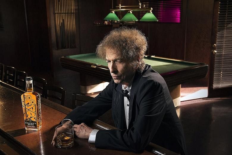 Bob Dylan in a promotional photograph (left) for his Heaven's Door whiskeys, which comprise (above from left) a straight bourbon, a "double-barrelled" whiskey and a straight rye.