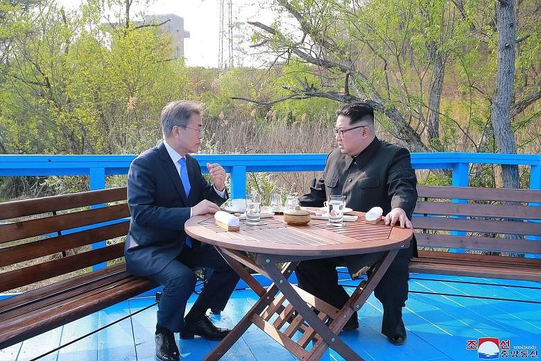 South Korean President Moon Jae In (left) and North Korean leader Kim Jong Un at Panmunjom village last Friday.