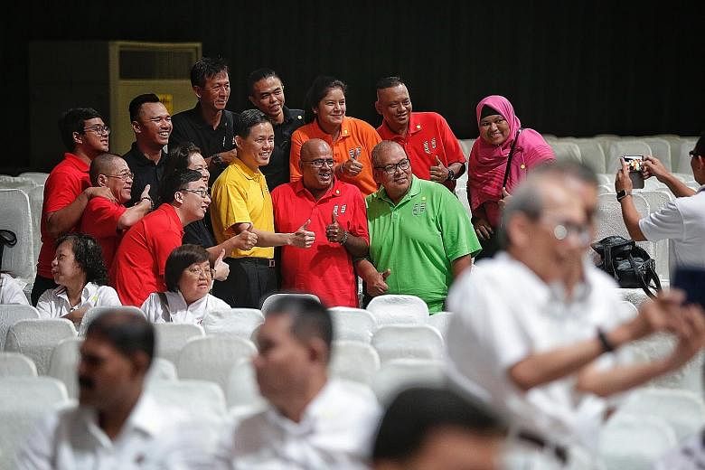 Outgoing NTUC secretary-general Chan Chun Sing (in yellow) posing for a photo with May Day Rally attendees yesterday. Several unionists described him as a warm and approachable leader with a sharp intellect.