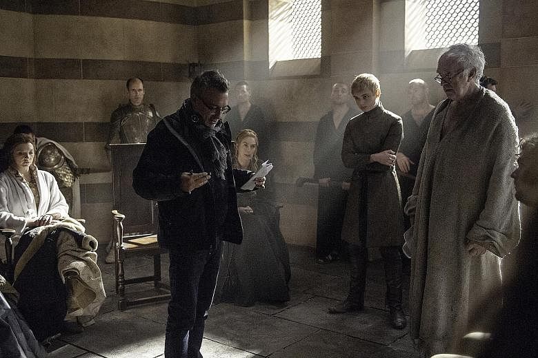 Film-maker Jeremy Podeswa in a scene from Game Of Thrones with actors (seated from far left) Natalie Dormer, Lena Headey, (standing) Dean-Charles Chapman and Jonathan Pryce.