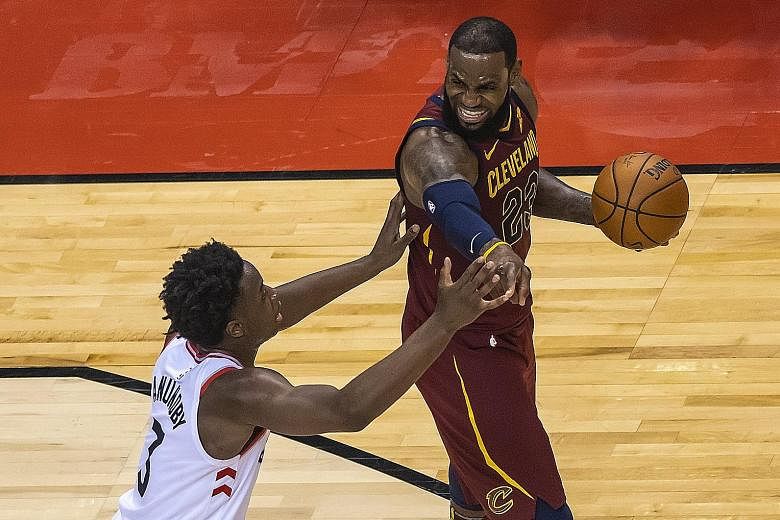 Cleveland's LeBron James holds off Toronto's Ogugua Anunoby during the Cavs' 113-112 overtime win against the Eastern Conference top seeds in their semi-final play-off on Tuesday.