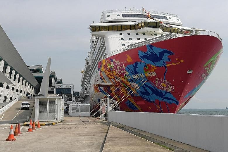 A notice (far right) put up at the cruise centre informing passengers of the cancellation of their cruise to Port Klang on Genting Dream on Wednesday.