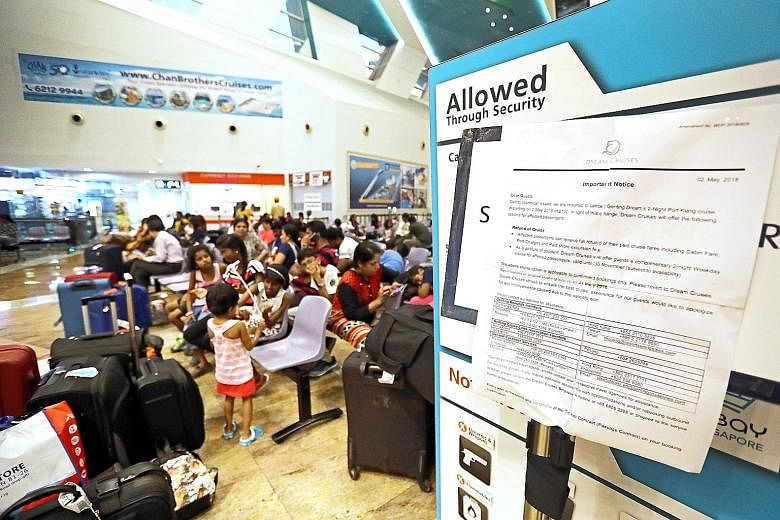 A notice (far right) put up at the cruise centre informing passengers of the cancellation of their cruise to Port Klang on Genting Dream on Wednesday.