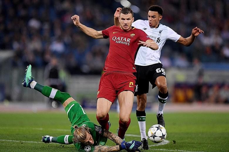 Roma striker Edin Dzeko being brought down by Liverpool goalkeeper Loris Karius in the second half but he was wrongly ruled offside. Roma were denied another penalty when defender Trent Alexander-Arnold (No. 66) appeared to handle the ball in the box